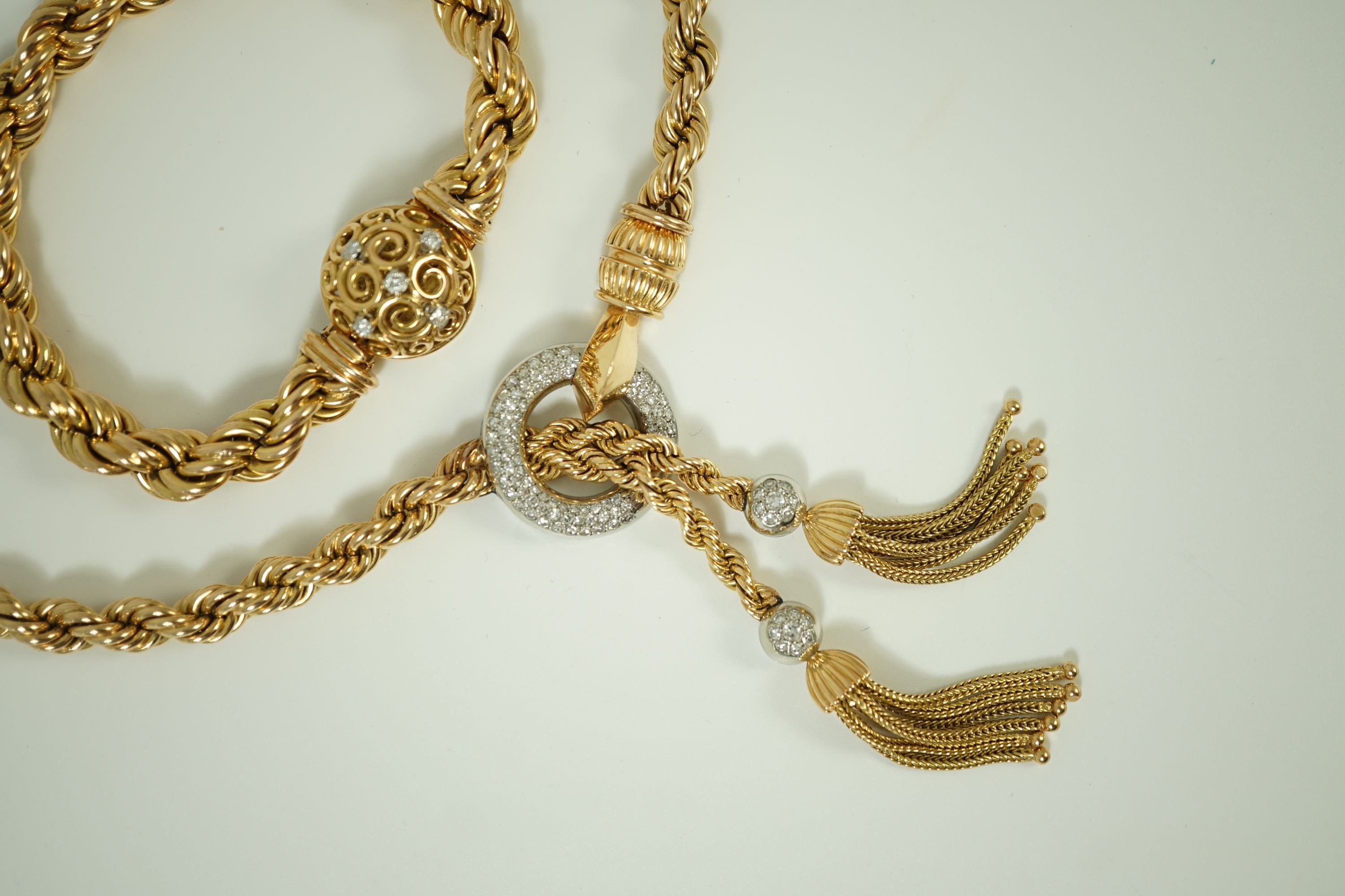 A modern heavy Middle Eastern gold and diamond set rope twist drop tassel necklace, together with a similar gold and diamond set bracelet
